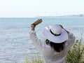 Girl waving in front the sea Royalty Free Stock Photo