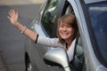 Girl waving goodbye from car Royalty Free Stock Photo