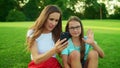 Girl waving hand at camera during video call. Family talking on smartphone Royalty Free Stock Photo