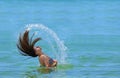 Girl waving her hair in the water