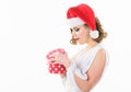 Girl wear santa claus hat. Woman attractive wear sexy dress and christmas santa hat. Girl hold polka dot gift box Royalty Free Stock Photo