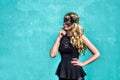 Girl wearing a black mask. Colorful tourqoise blue background Royalty Free Stock Photo