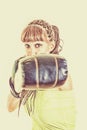 Girl wearing boxing gloves ready to fight and punching or hitting camera or you Royalty Free Stock Photo