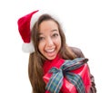 Excited Teen Girl Wearing A Christmas Santa Hat with Bow Wrapped Gift Iisolat Royalty Free Stock Photo