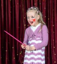 Girl Wearing Clown Make Up Holding Over Sized Comb Royalty Free Stock Photo