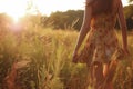 girl wearing a dress with goldenrod pattern in field