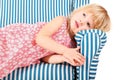 Girl wearing dress is lying on comfortable chair