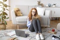 Girl wearing eyeglasses, sitting on the floor, reading book Royalty Free Stock Photo