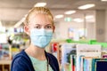 A girl wearing face mask at the llibrary during the COVID-19 pandemic