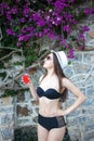 Girl wearing hat, glasses and swimsuit with the glass of juice Royalty Free Stock Photo