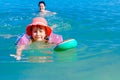 Girl is wearing inflatable armbands, learning to swim in the sea Royalty Free Stock Photo