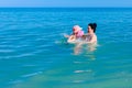 Girl is wearing inflatable armbands, learning to swim in the sea Royalty Free Stock Photo