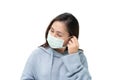 Girl wearing blue winter coat and mask againt flu and covid-19,corona virus by putting ear hook