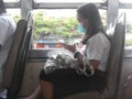 Girl wearing mask on the bus. Pm2.5 dust air pollution. Bangkok, Thailand Royalty Free Stock Photo