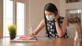 A girl wearing a mask sitting at work.She works at home to protect against the Covid-19 virus