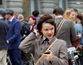 Girl wearing old fashioned tweed clothes fixing the hat