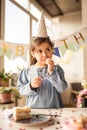 Girl wearing party hat looking away and thinking about something Royalty Free Stock Photo