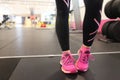 girl wearing pink running shoes on treadmill