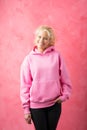 Girl wearing pink sweatshirt on pink background Royalty Free Stock Photo