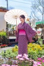 The girl is wearing a pink traditional yukata, which is the national dress of Japan