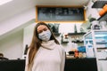 Girl wearing protective mask sitting in coffee shop Royalty Free Stock Photo