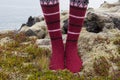 Girl wearing red Icelandic wool socks standing in.