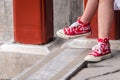 Girl Wearing Red Shoes with Coca Cola Logo on it