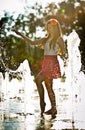 Girl wearing red skirt playing water fountain Royalty Free Stock Photo