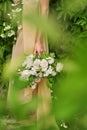 A girl wearing a romantic pink dress holding a bouquet of white roses, standing outdoors, green background Gentle pastel colors Cu Royalty Free Stock Photo