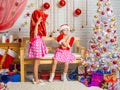 Girl wearing Santa Claus bag on his head, the other girl was offended sitting on the bench Royalty Free Stock Photo