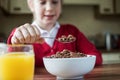 Girl Wearing School Uniform Eating Bowl Of Sugary Breakfast Cereal In Kitchen Royalty Free Stock Photo