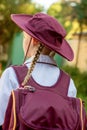 A girl wearing school uniform, white shirt, maroon backpack and a hat Back to school. Return to classrooms after COVID-19 outbreak