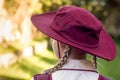 A girl wearing school uniform, white shirt, maroon backpack and a hat Back to school. Return to classrooms after COVID-19 outbreak