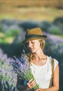 Girl wearing straw hat with a bouquet of lavender flowers Royalty Free Stock Photo