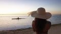 Girl Enjoys the View of Paddler from Beach Royalty Free Stock Photo