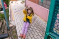 Girl is wearing tire swings. In summer, the child plays outdoors