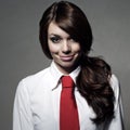 The girl is wearing a white shirt and red tie Royalty Free Stock Photo