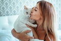 the girl wears erotic lingerie and touches the cat. fluffy and soft. feeling of Royalty Free Stock Photo