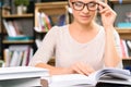 Girl wears glasses to read a textbook