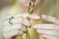 The girl weaves pigtails. Close-up of a hand with a pigtail. The process of creating a hairstyle