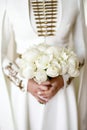 a girl in a wedding national Caucasian dress holds a wedding bouquet