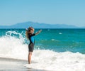 Girl in a wetsuit on the beach