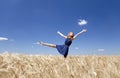 Girl at wheat field in summer day. Royalty Free Stock Photo