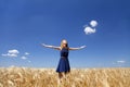 Girl at wheat field in summer day. Royalty Free Stock Photo