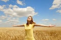 Girl at wheat field at summertime. Royalty Free Stock Photo