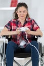 Girl in wheelchair holding computer joystick Royalty Free Stock Photo