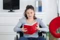 Girl in wheelchair reading book Royalty Free Stock Photo