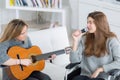 Girl in wheelchair singing along to friend playing guitar Royalty Free Stock Photo