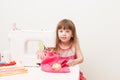 The girl is engaged in needlework using sewing machine Royalty Free Stock Photo
