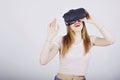 Girl on a white background plays virtual reality. Games and films vr. Emotions